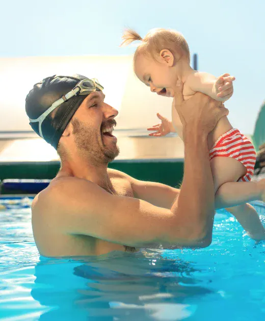 A father and daughter enjoying a swimming pool